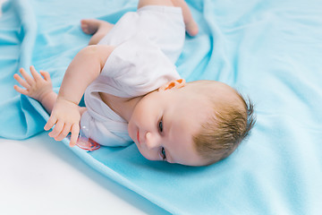 Image showing baby lying on a blue blanket