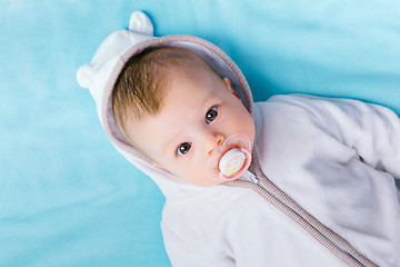 Image showing baby in the hood on a blue blanket