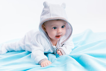 Image showing baby in the hood on a blue blanket