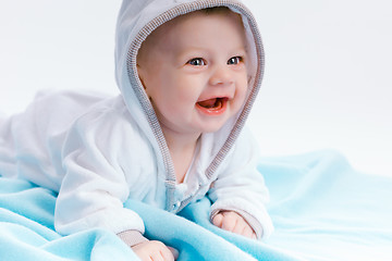 Image showing baby in the hood on a blue blanket