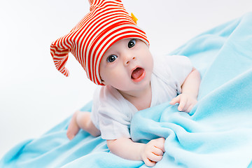 Image showing toddler in a striped hat on a blue blanket