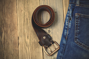 Image showing Vintage blue jeans and old leather belt