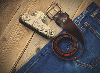 Image showing rangefinder camera, vintage leather belt and blue jeans