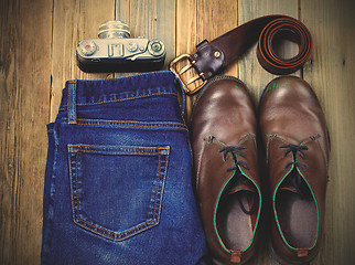 Image showing Still life with rangefinder camera, brown boots, leather belt an