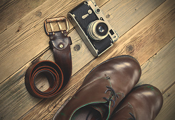 Image showing sturdy brown boots, leather belt, and rangefinder camera