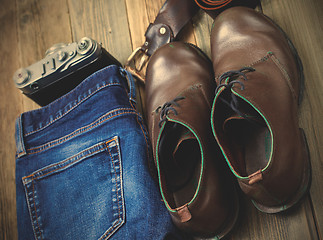 Image showing blue jeans, brown boots, leather belt and rangefinder camera