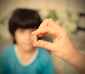 Image showing doctor with pill and boy