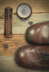 Image showing brown boots, shoe polish and shoe brush