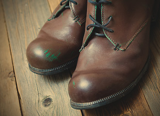 Image showing Two brown boots on old boards