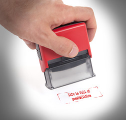 Image showing Plastic stamp in hand, isolated