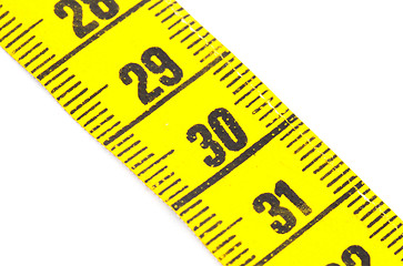 Image showing Yellow measuring tape isolated - selective focus