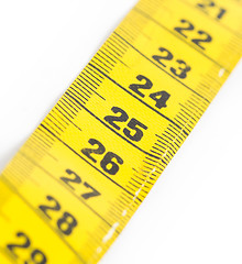 Image showing Yellow measuring tape isolated - selective focus