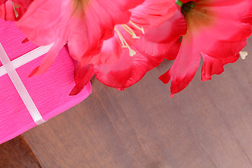 Image showing present gift box and flower bouquet on silk