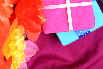 Image showing present gift box and flower bouquet on silk