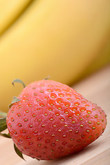 Image showing healthy strawberry smoothie with fruits on wooden background