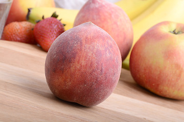 Image showing peach,  apple and strawberry on wooden plate 