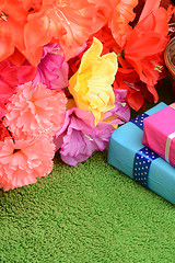 Image showing present gift box and flower bouquet on silk