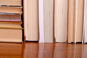 Image showing Old books leaning against each other for sale