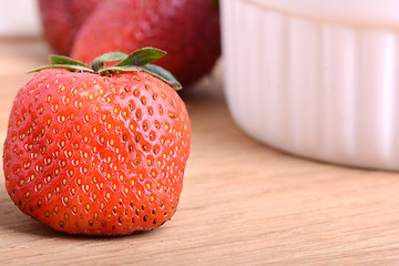 Image showing Close up strawberry on wooden plate
