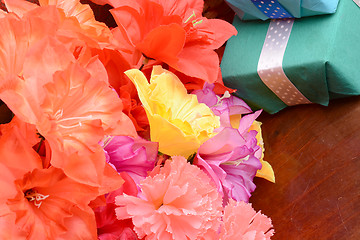 Image showing present gift box and flower bouquet on silk