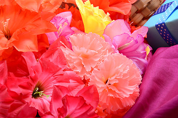 Image showing present and flower bouquet on silk