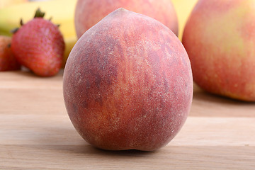 Image showing peach,  apple and strawberry on wooden plate 