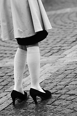 Image showing female legs in socks and black shoes 