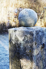 Image showing granite ball on a pedestal covered with frost