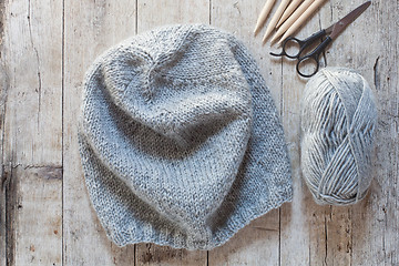 Image showing wool grey hat, knitting needles and yarn