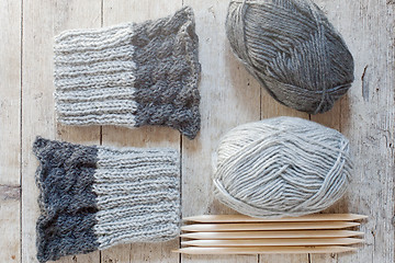 Image showing wool grey legwarmers, knitting needles and yarn