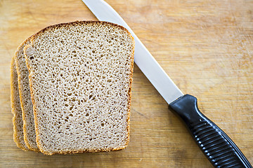 Image showing Bread and knife on breadboard