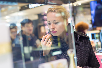 Image showing Beautiful woman shopping in beauty store.