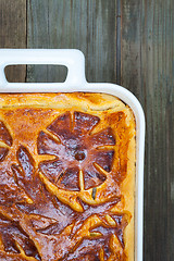 Image showing pie in a white ceramic pot on vintage boards