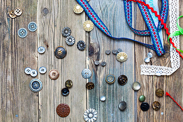 Image showing scattered vintage buttons and diverse colored band