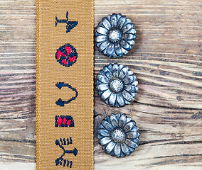 Image showing vintage tape with embroidered ornaments and old buttons flowers