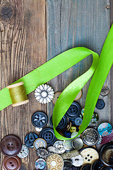 Image showing set of vintage buttons with green tape and spool of thread