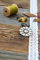 Image showing vintage buttons with lace tape