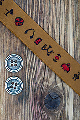 Image showing vintage band with embroidered ornaments and old button