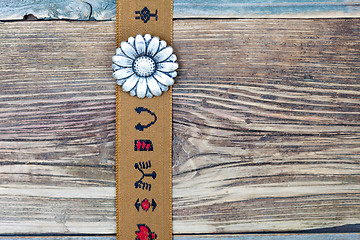 Image showing vintage tape with embroidered ornaments and old flower button