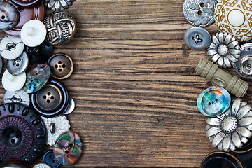 Image showing set of vintage buttons on aged boards