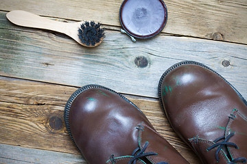 Image showing Still life with brown boots, shoe polish and shoe brush