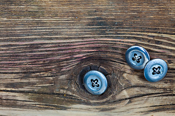 Image showing vintage buttons on the aged textured boards