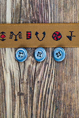 Image showing vintage tape with embroidered ornaments and old buttons