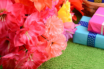 Image showing present gift box and flower bouquet on silk