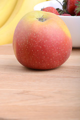 Image showing Fruits. Arrangement of various fresh ripe fruits: bananas, apple and strawberries closeup