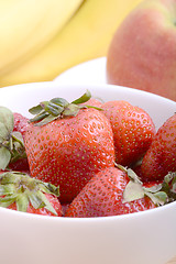 Image showing Fruits. Arrangement of various fresh ripe fruits: bananas, apple and strawberries closeup