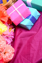 Image showing present gift box and flower bouquet on silk