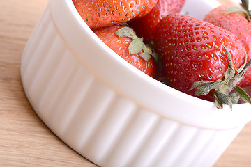 Image showing Close up strawberry on wooden plate