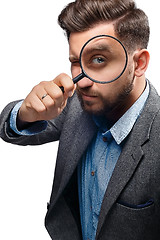 Image showing Man with magnifying glass on white background