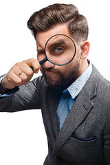 Image showing Man with magnifying glass on white background